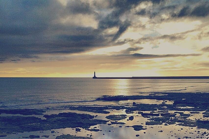 SCENIC VIEW OF SEA AT SUNSET