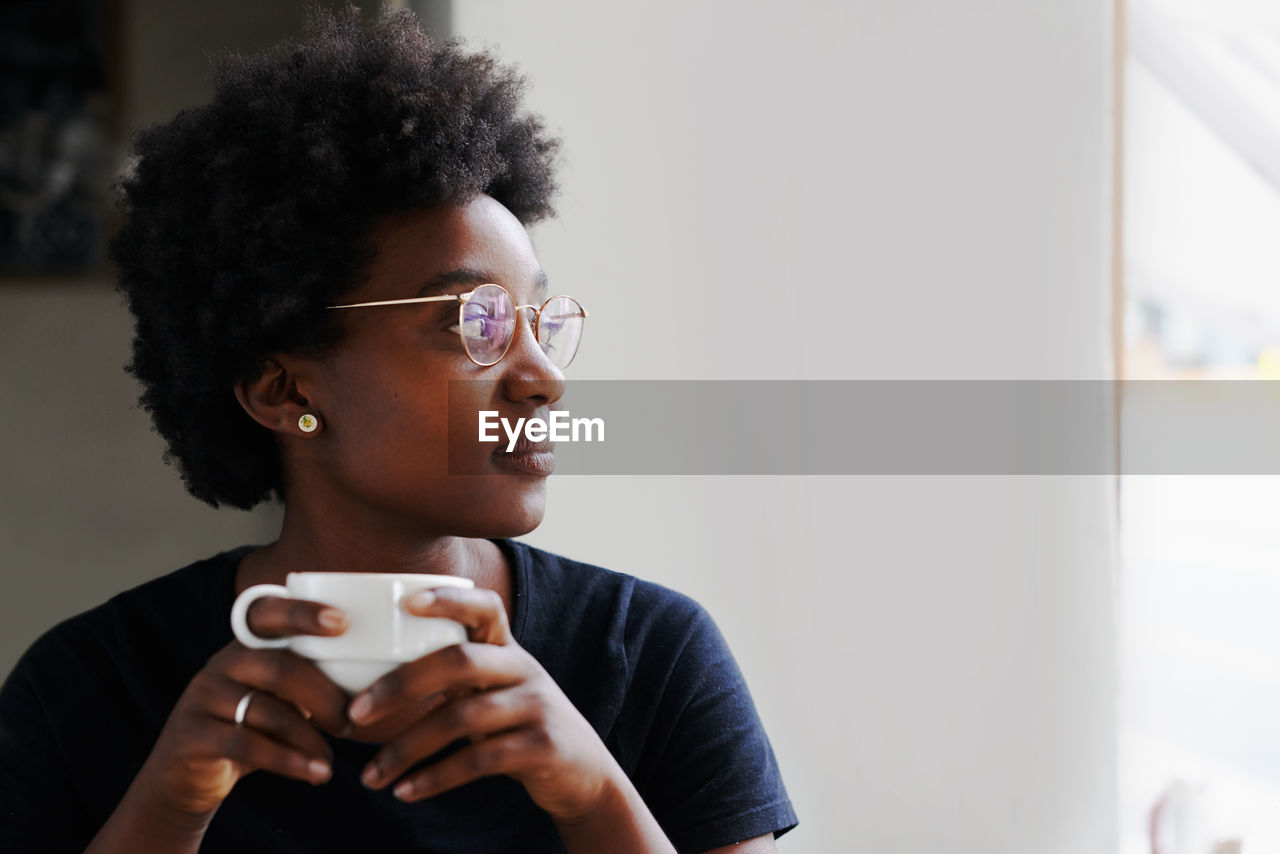 Young woman drinking coffee cup