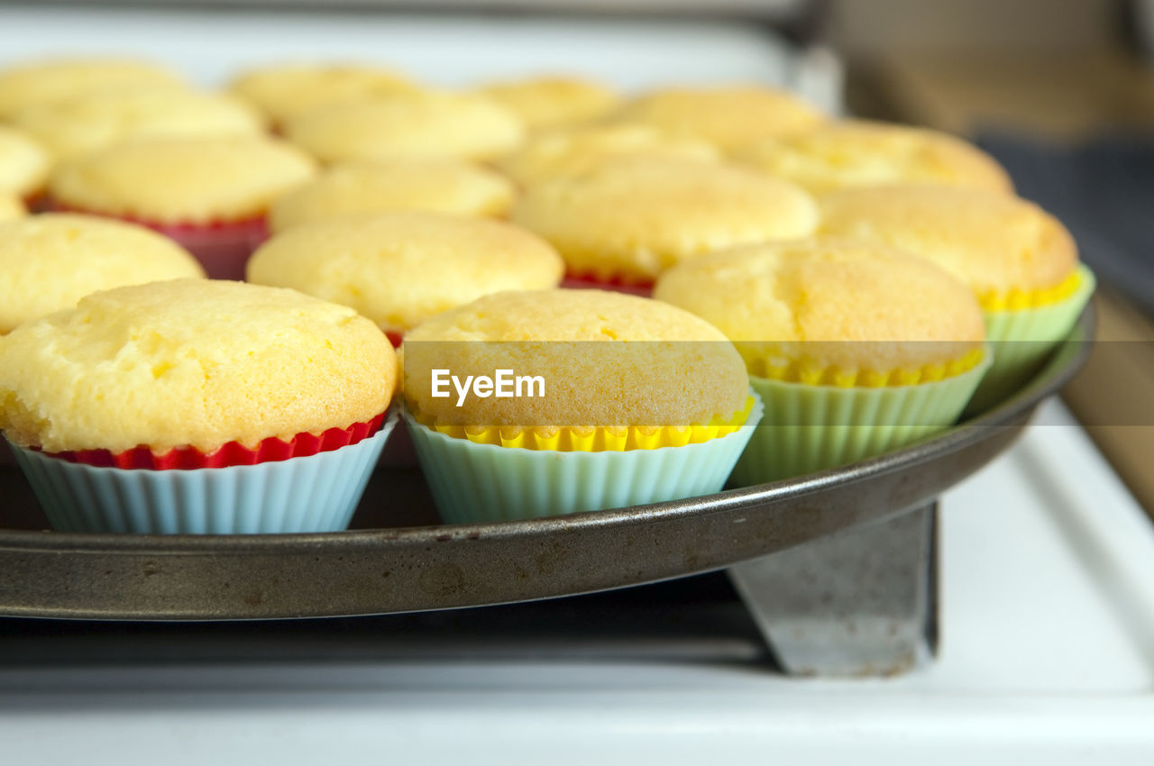 Freshly baked cupcakes cooling on a tray