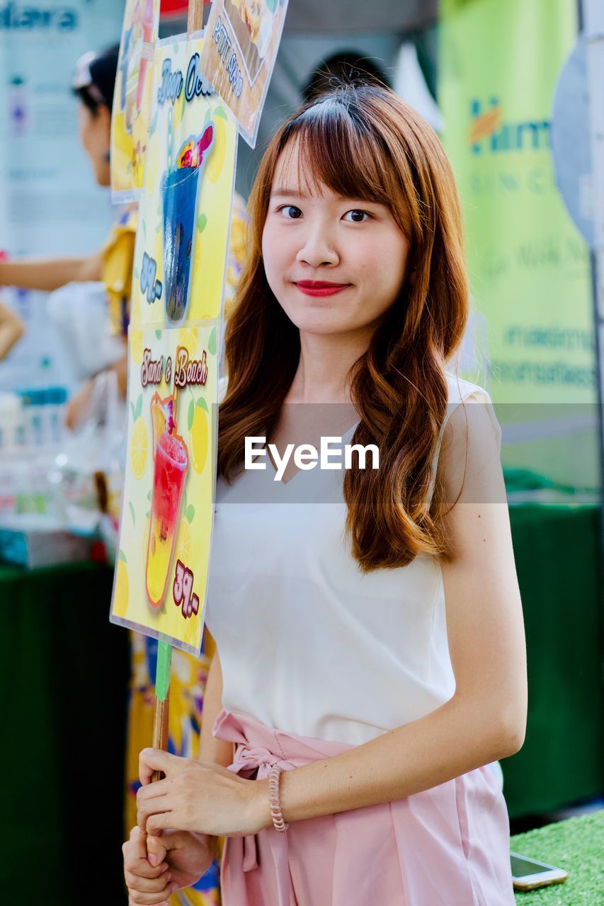 Portrait of smiling young woman at market