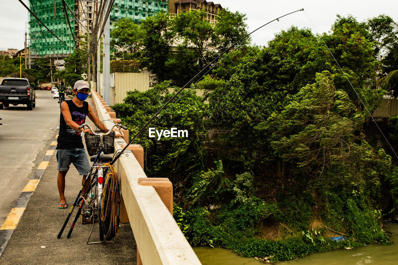 PEOPLE RIDING BICYCLE ON ROAD