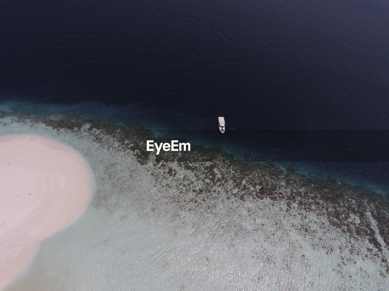 HIGH ANGLE VIEW OF WAVES ON SHORE