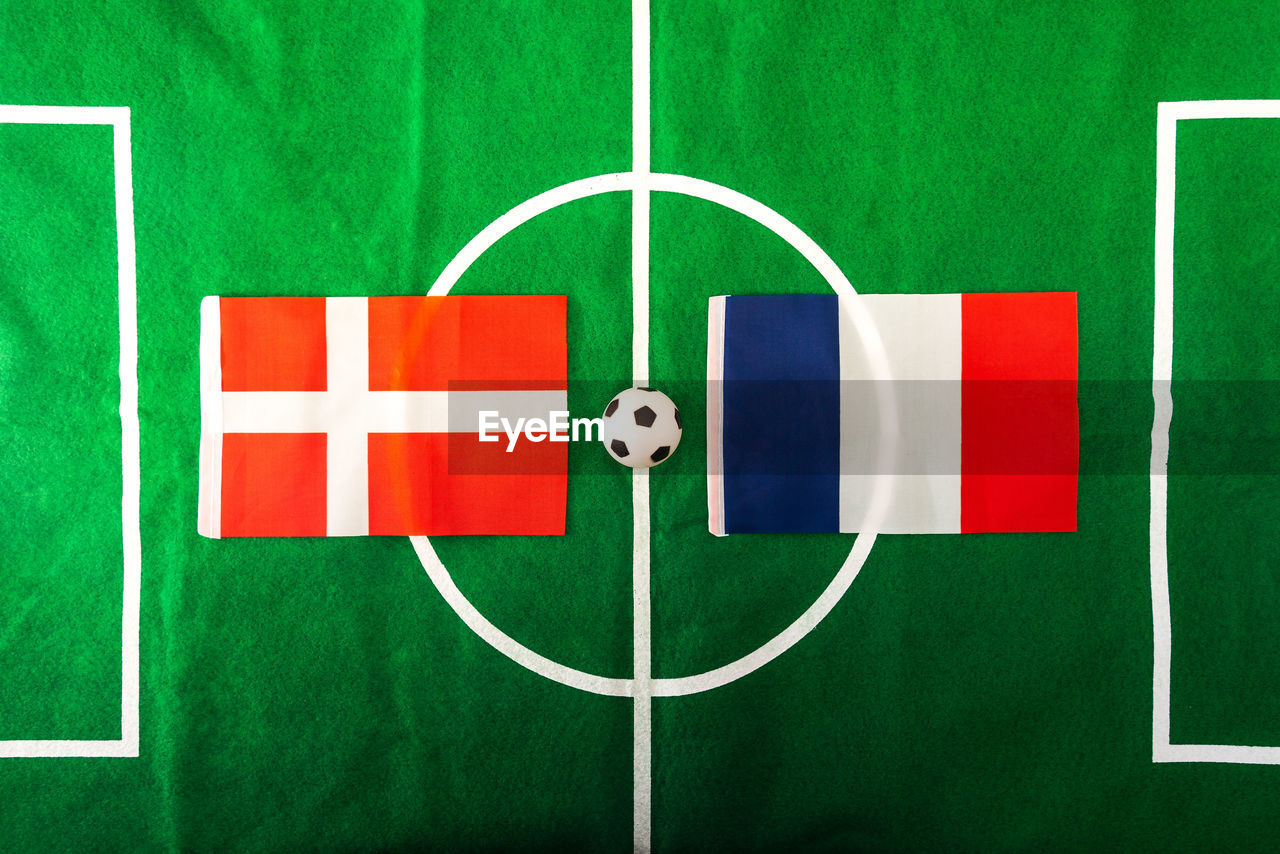Close-up of flags and ball on soccer field