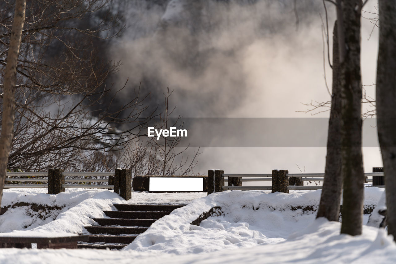 Snow covered field during foggy weather