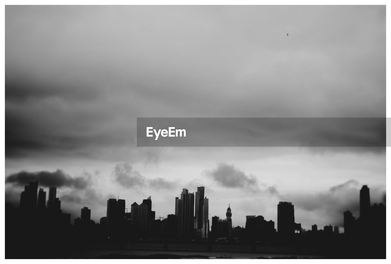 SKYSCRAPERS IN CITY AGAINST CLOUDY SKY