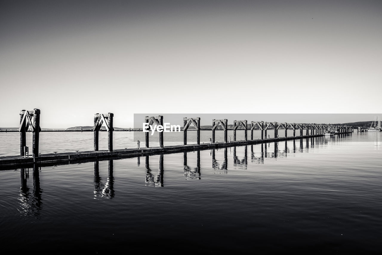 Pier on sea against clear sky