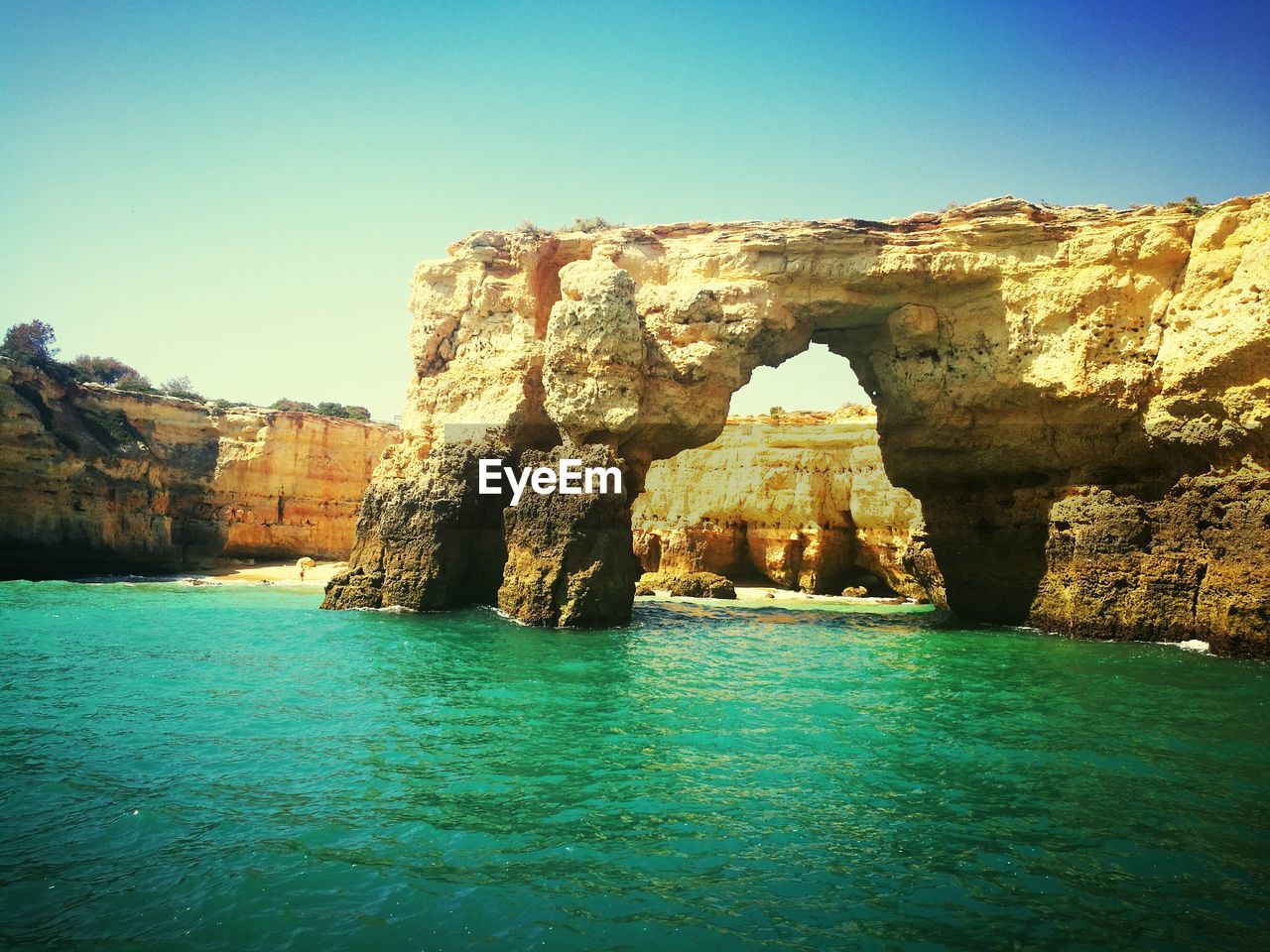 Scenic view of sea against clear blue sky