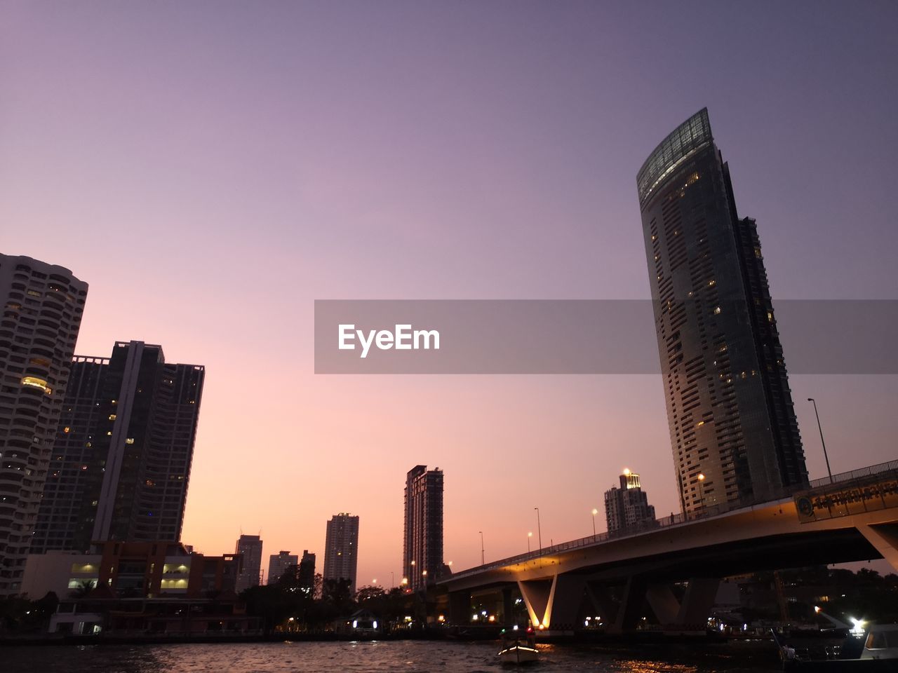 ILLUMINATED BUILDINGS AGAINST SKY DURING SUNSET