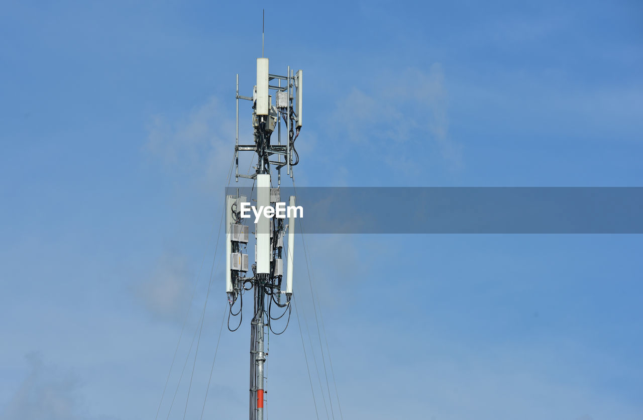 Low angle view of communications tower against sky