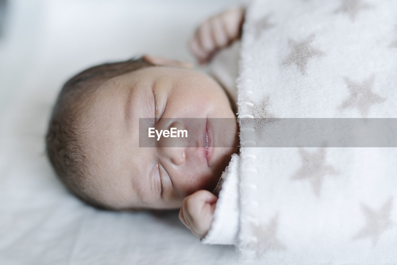 Sleeping baby lying in crib