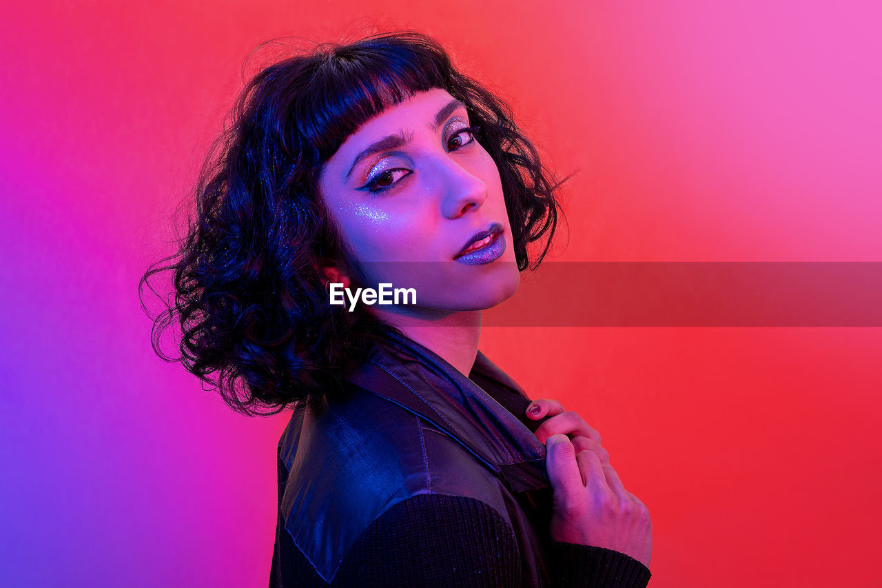 Portrait of smiling modern woman with trendy look and bright colors.
