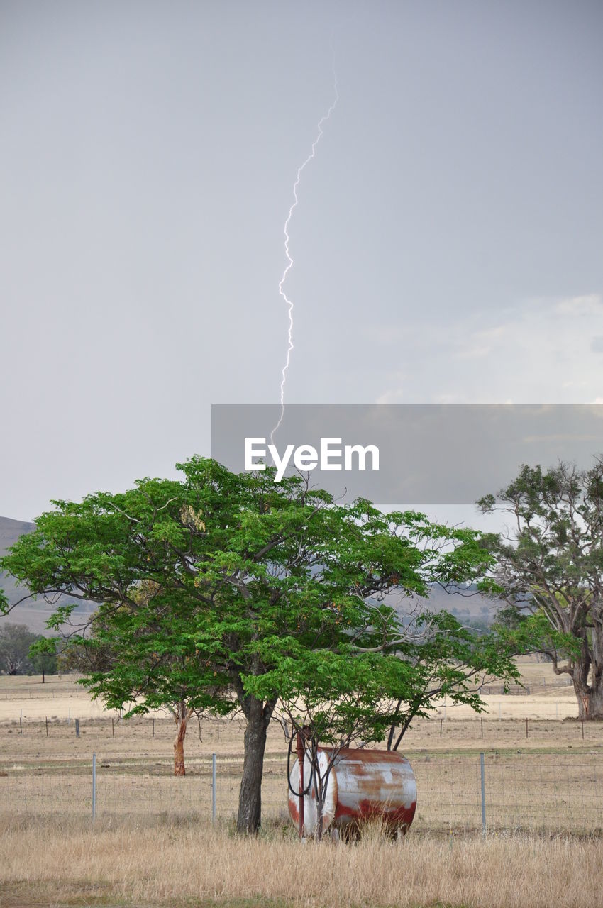 Lightning over landscape against sky