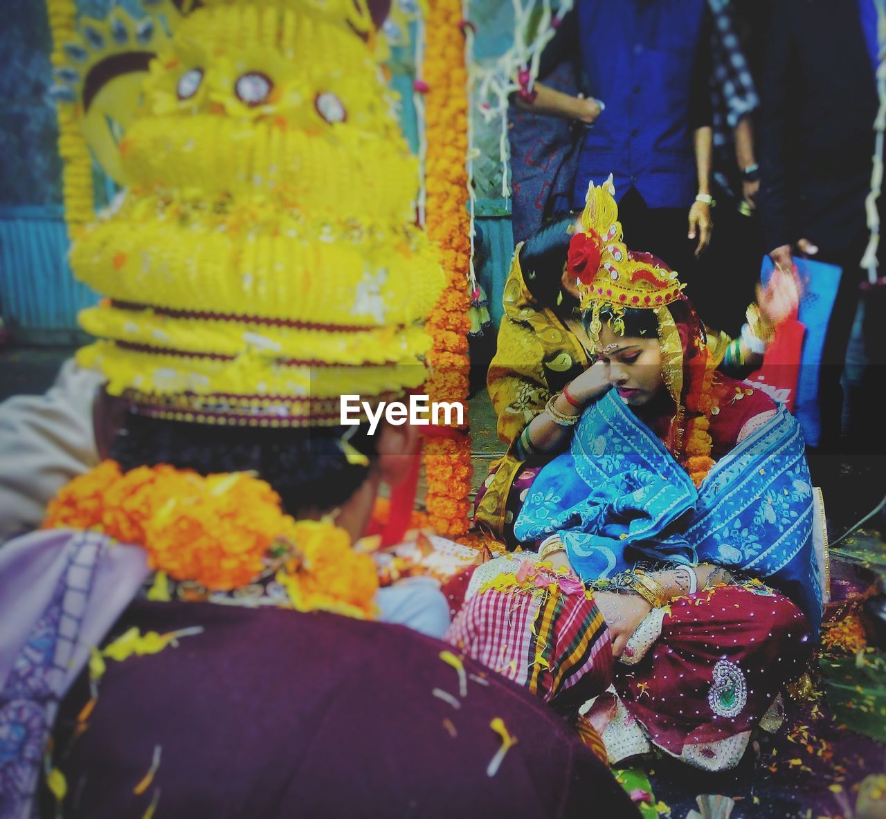 Bride and bridegroom sitting during wedding ceremony