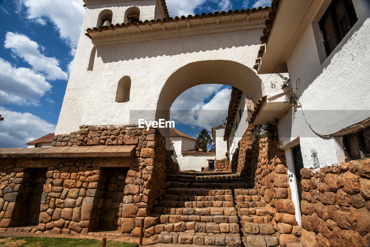 architecture, built structure, building exterior, cloud, sky, building, history, nature, the past, travel destinations, low angle view, religion, no people, day, ancient history, travel, wall, tourism, outdoors, house, ruins, sunlight, belief, place of worship, wall - building feature, tower, arch, blue, stone material, old, brick