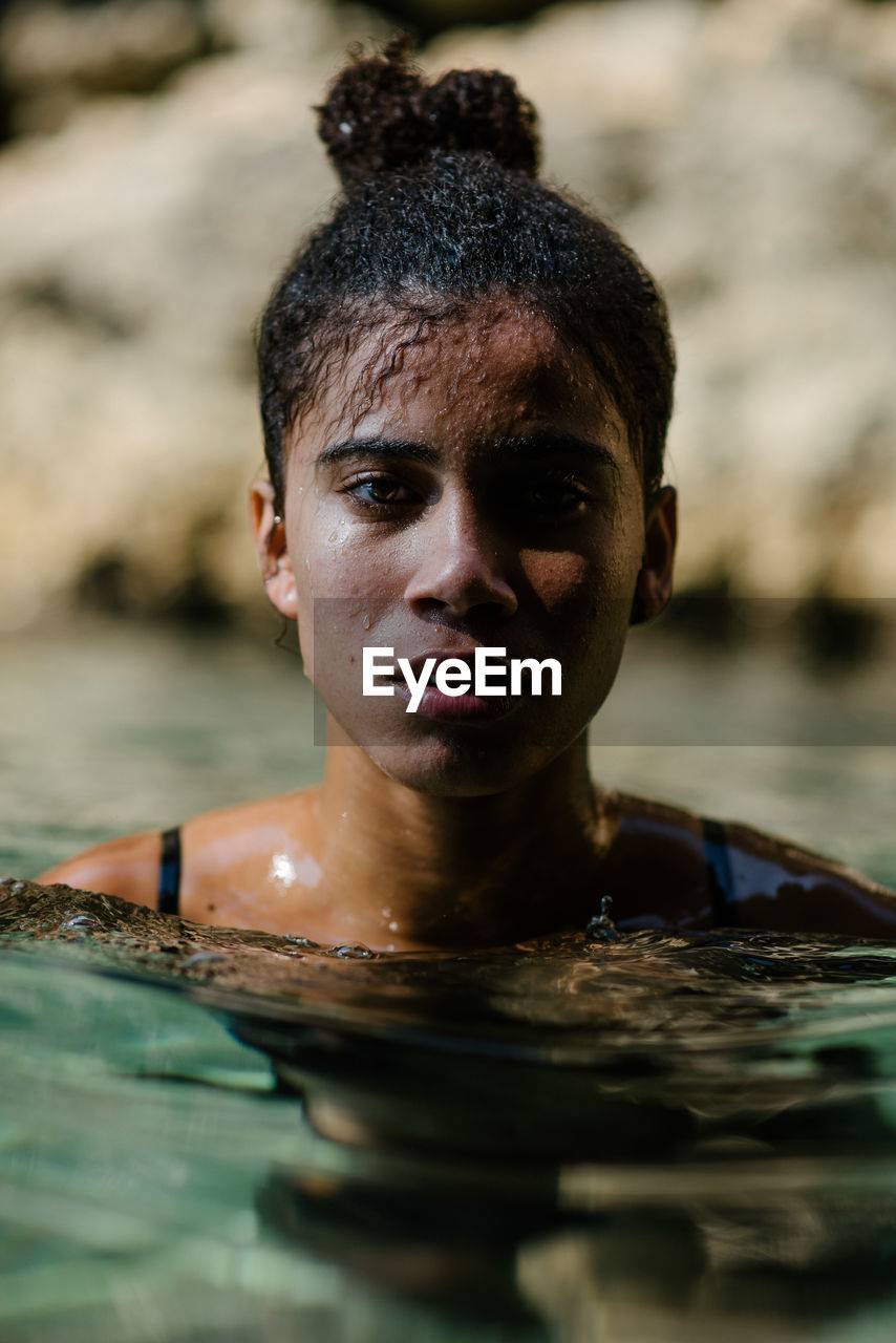 Portrait of young woman swimming in sea