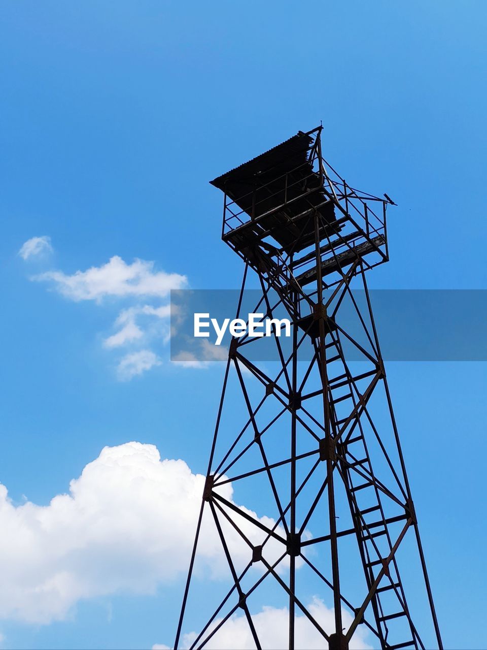 Low angle view of water tower against blue sky