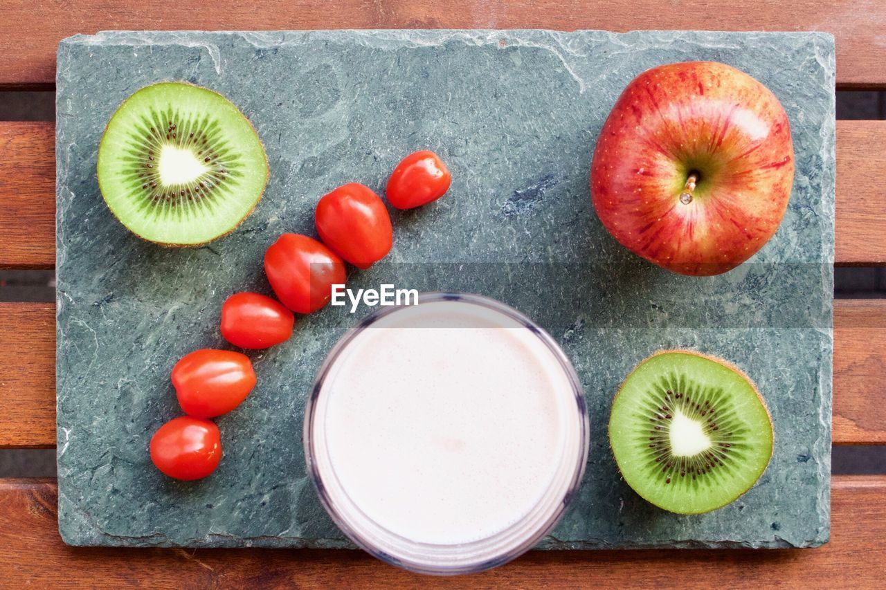 Directly above shot of fruits and tomatoes on slate