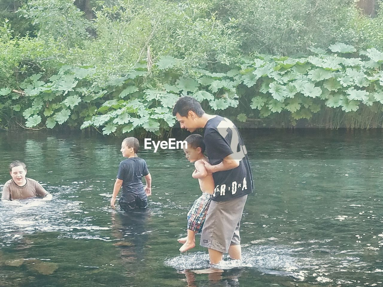 FRIENDS STANDING IN WATER