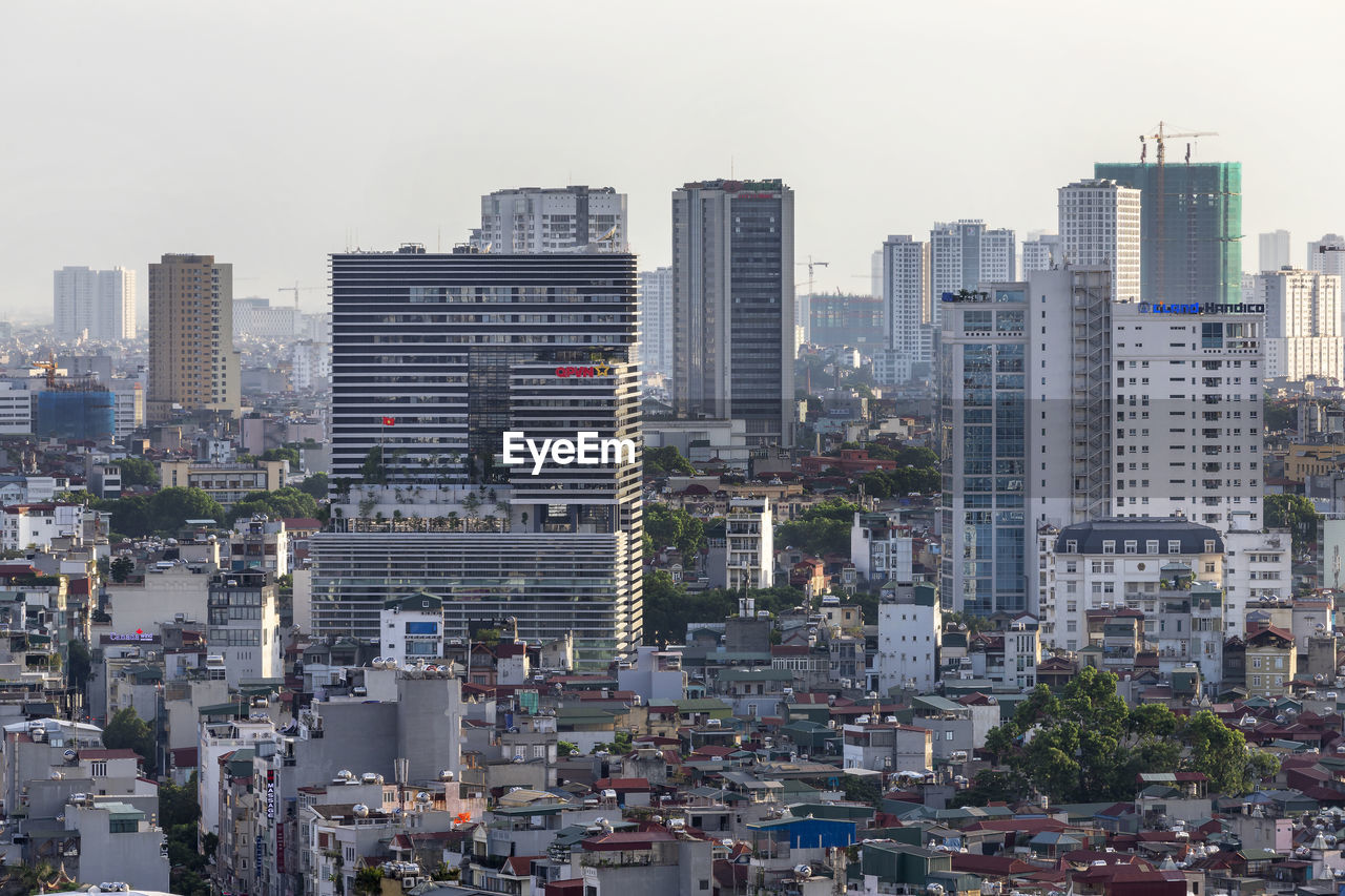 MODERN BUILDINGS IN CITY AGAINST SKY