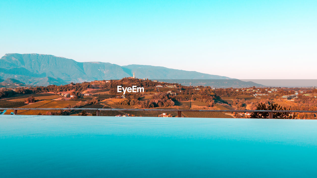 Artistic picture of infinity pool over prosecco hills.