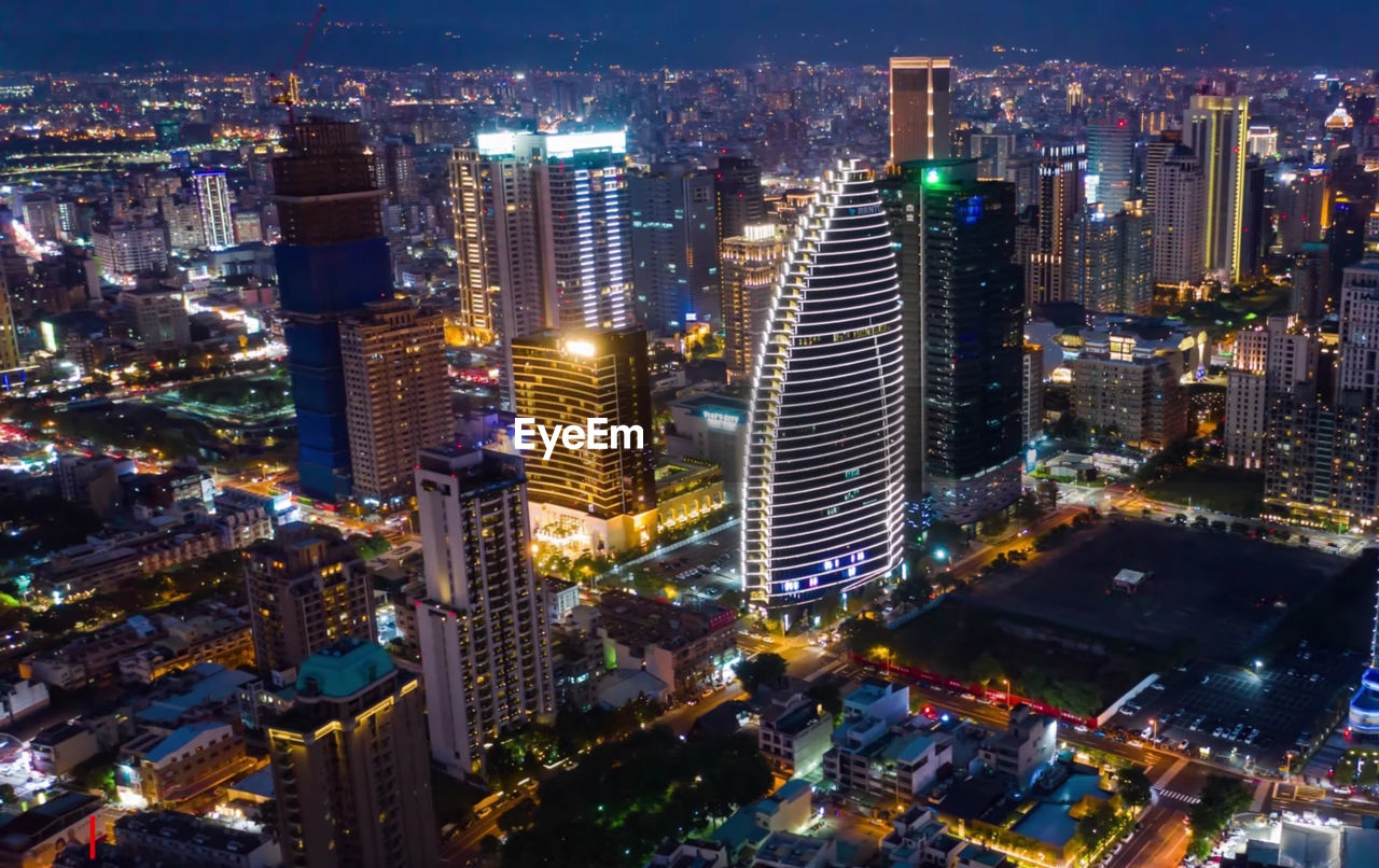 High angle view of illuminated buildings in city at night