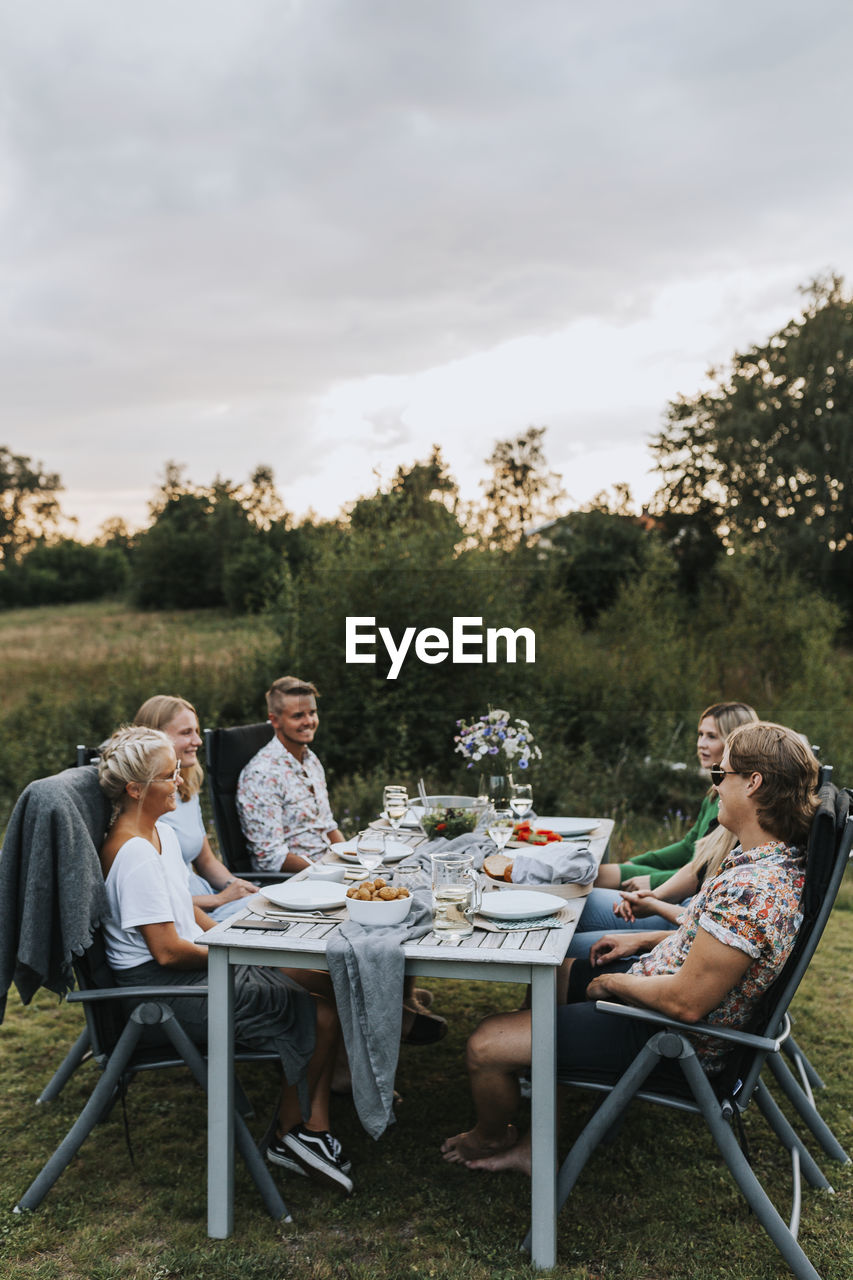 Friends having meal in garden