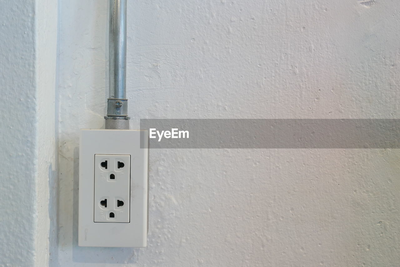 Close-up of electric outlet on wall