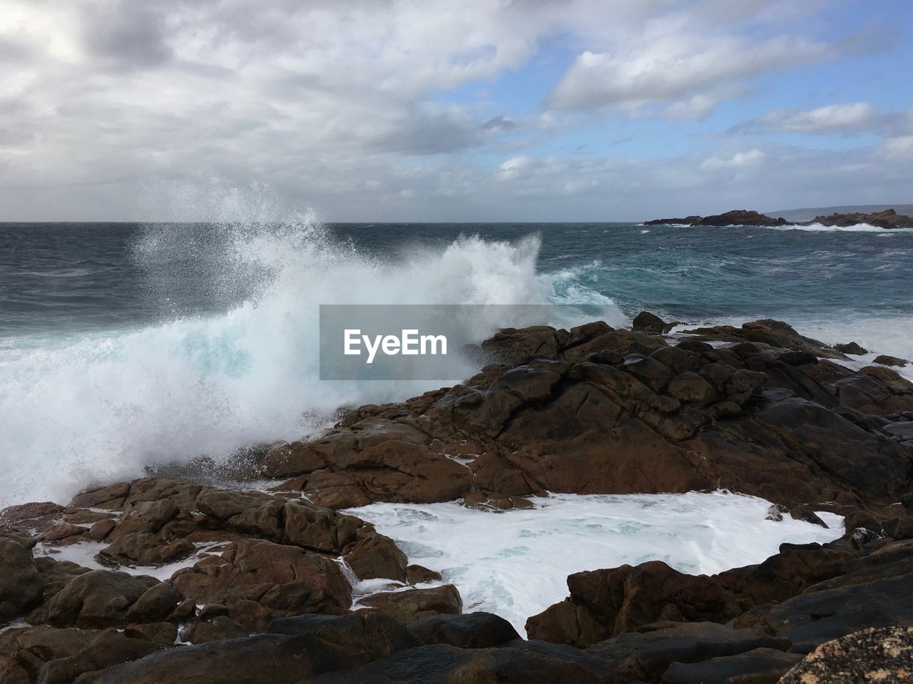 SCENIC VIEW OF SEA WAVES AGAINST ROCKS