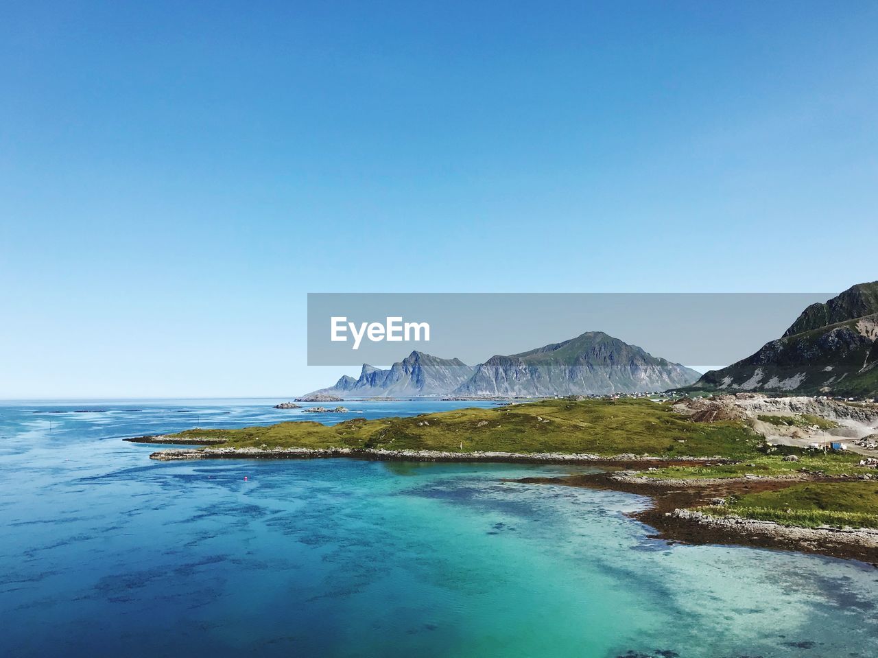 Scenic view of sea against clear blue sky