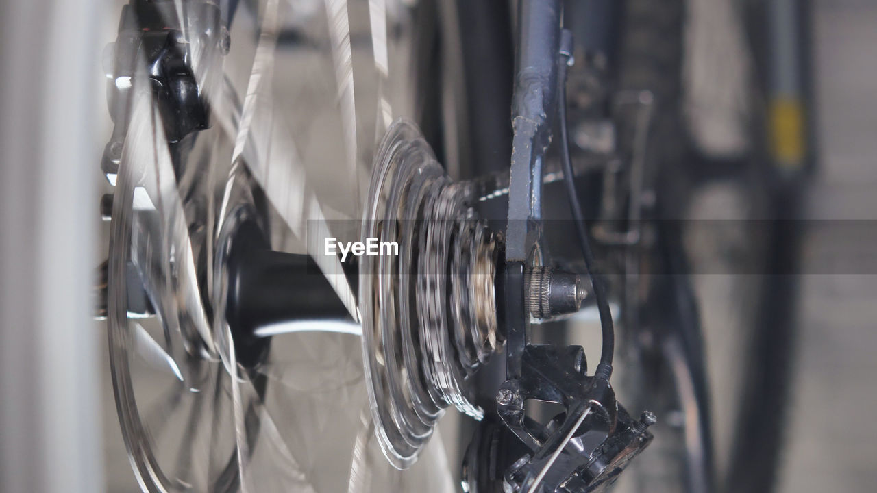 close-up, no people, bicycle, vehicle, indoors, wheel, focus on foreground, iron, selective focus, metal, light