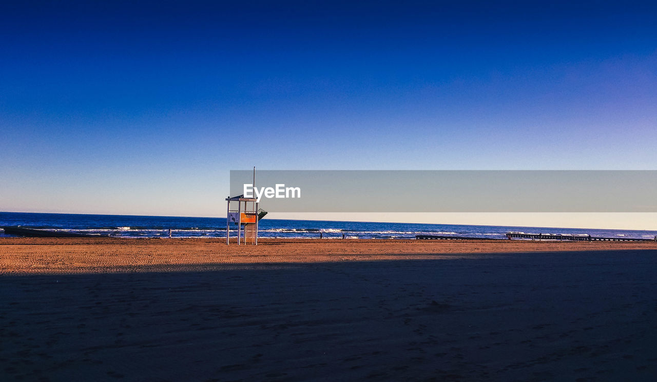 Scenic view of sea against clear blue sky