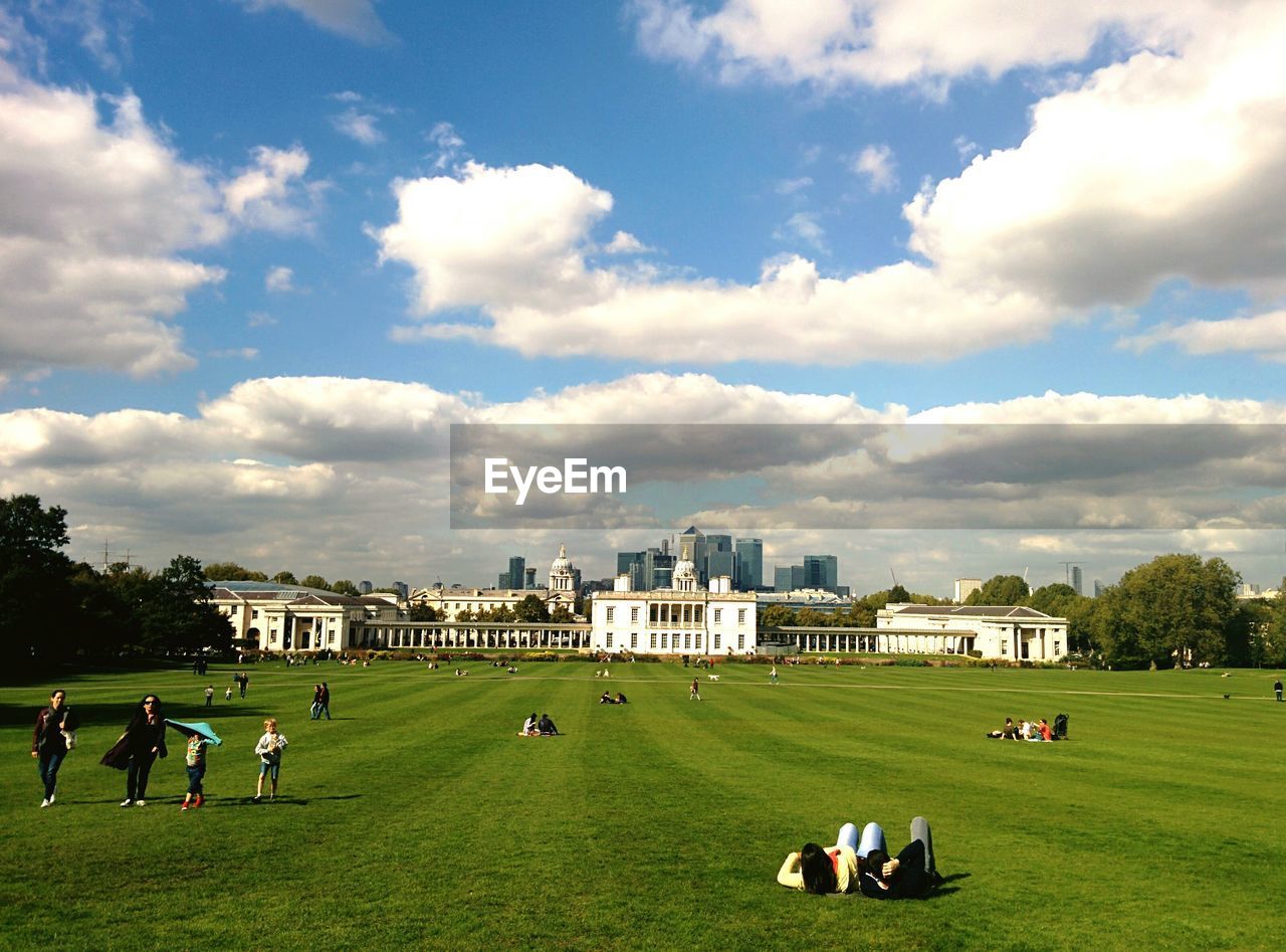 PEOPLE IN PARK AGAINST SKY