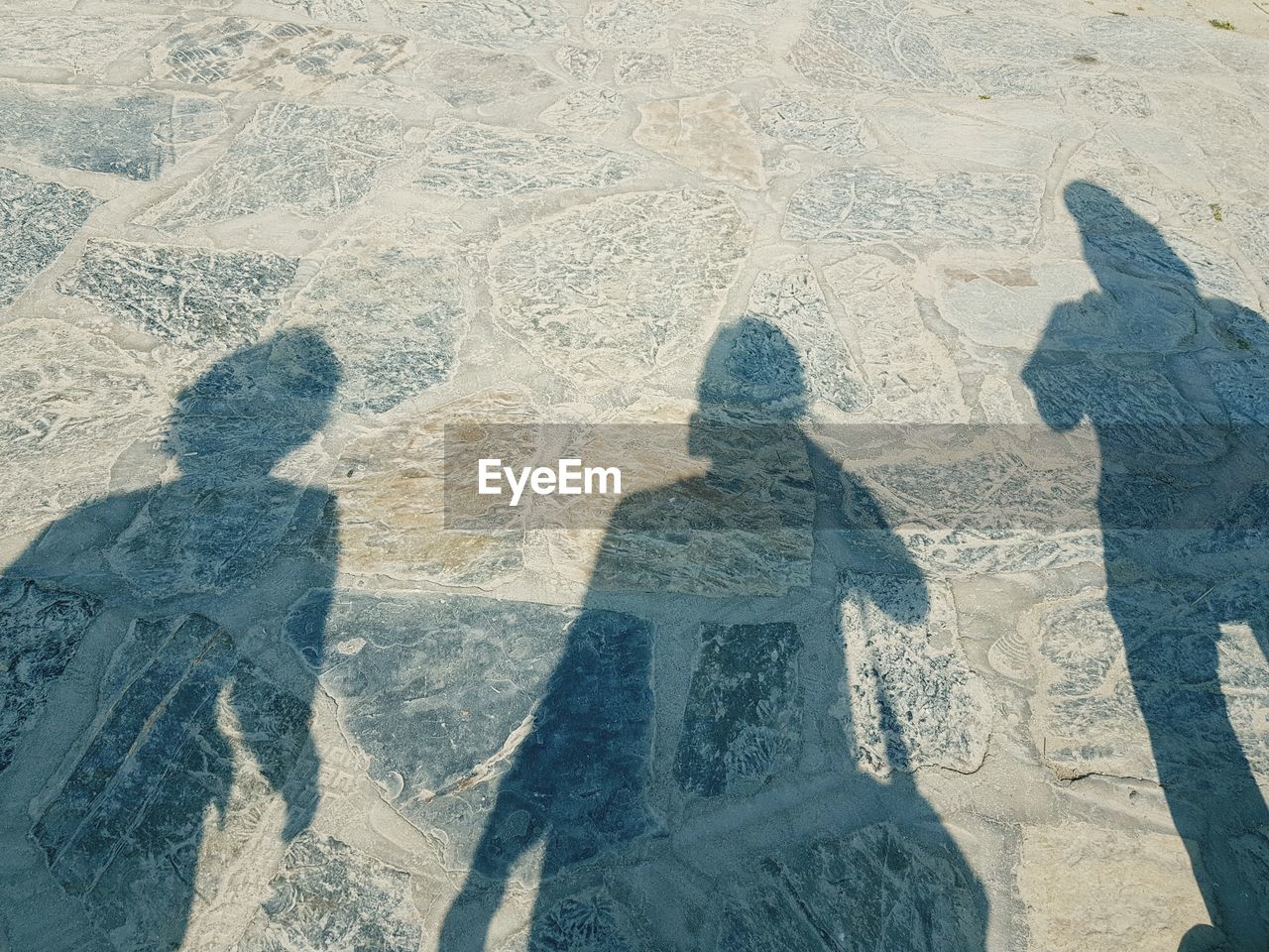 HIGH ANGLE VIEW OF PEOPLE SHADOW ON THE BEACH
