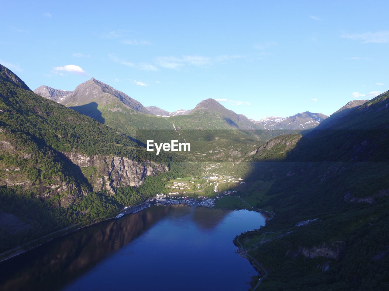 Scenic view of river amidst mountains against sky