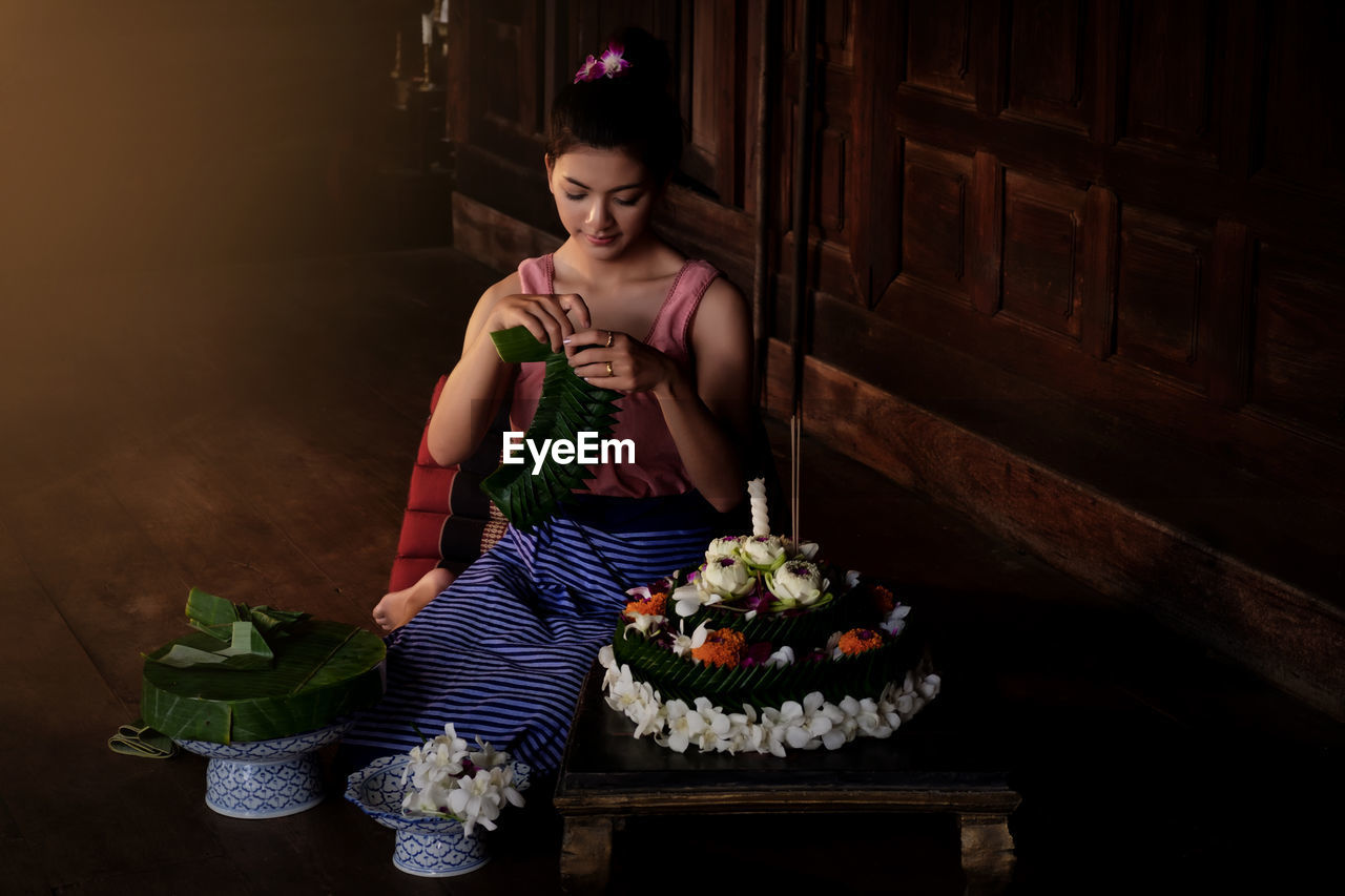 Young woman celebrating loi krathong