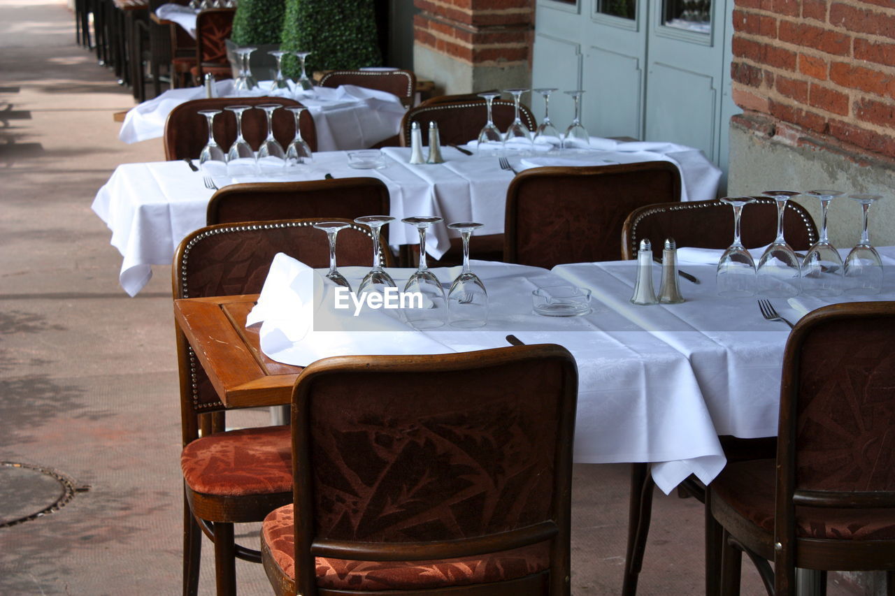 Outdoor restaurant table prepared before the wind