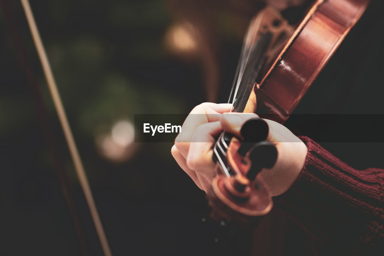 Cropped hands playing violin