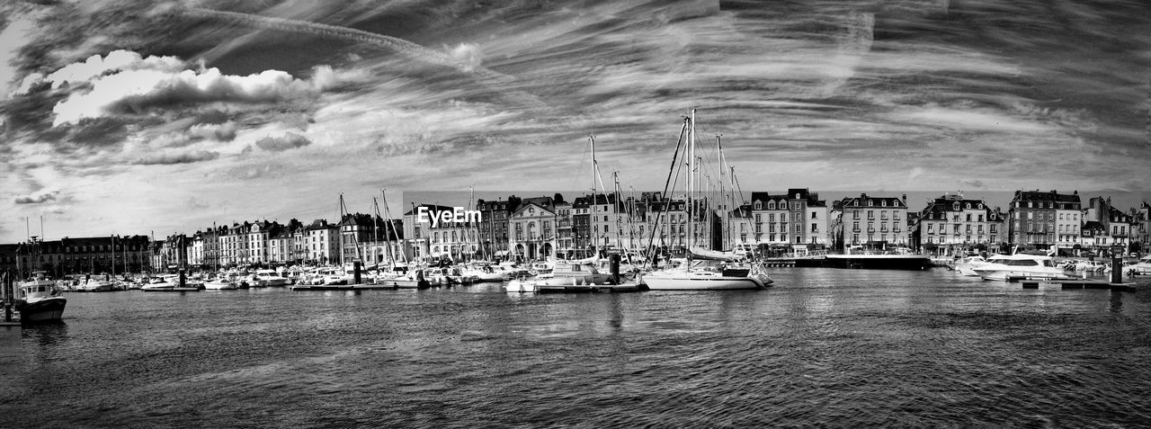 VIEW OF HARBOR AGAINST CLOUDY SKY