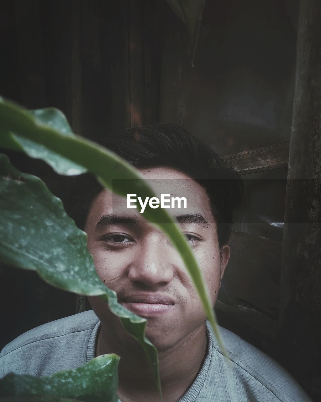 Close-up portrait of man looking by plants