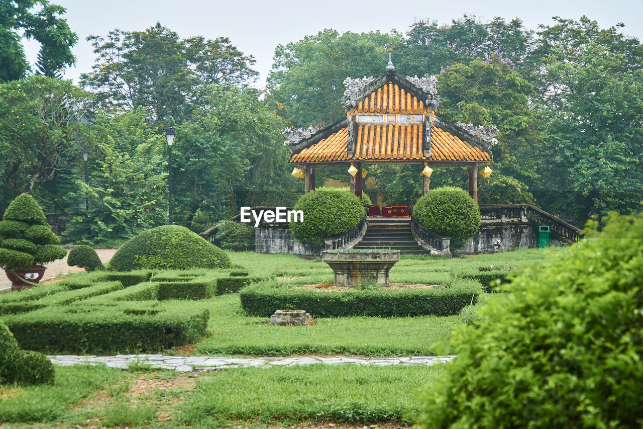 Gazebo by trees against sky