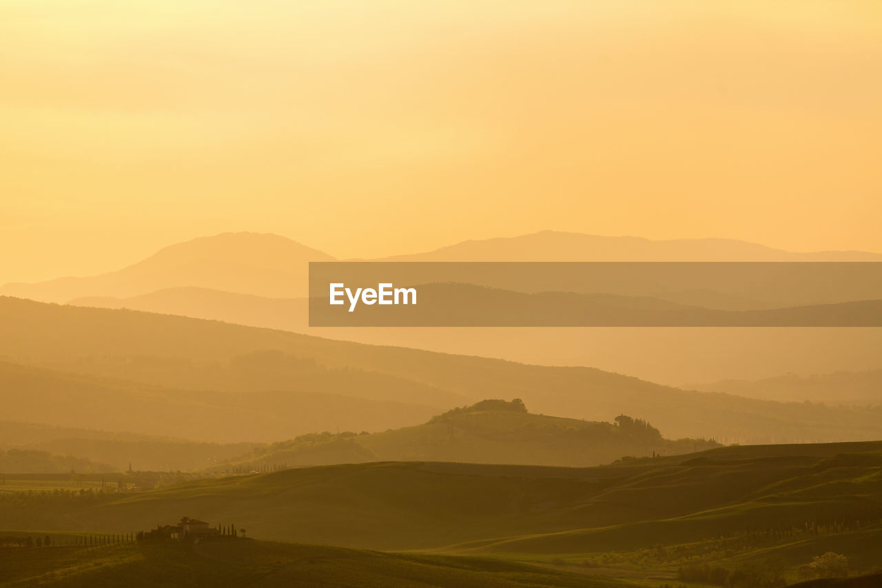 Sunset over a rolling landscape