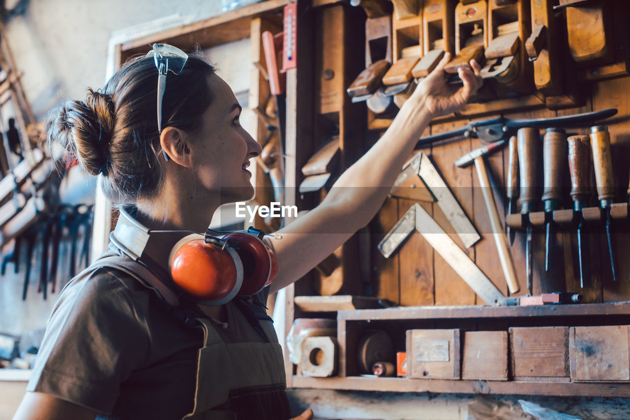 Female carpenter working in workshop