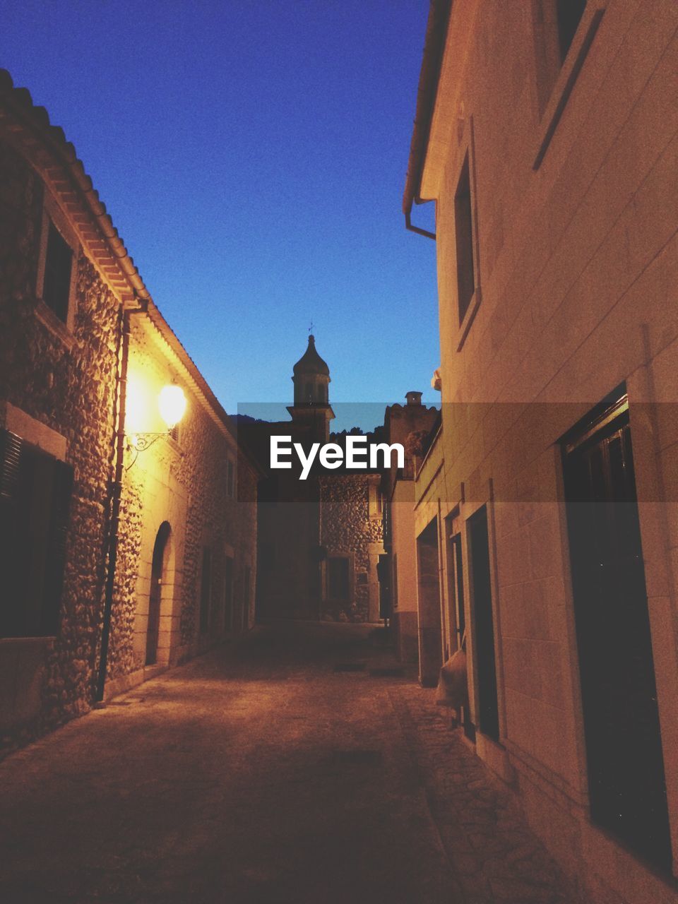 STREET AMIDST BUILDINGS AGAINST SKY