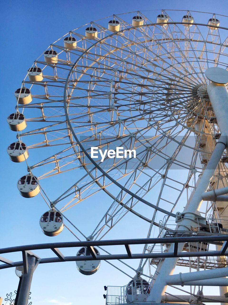 Low angle view of ferris wheel against clear sky