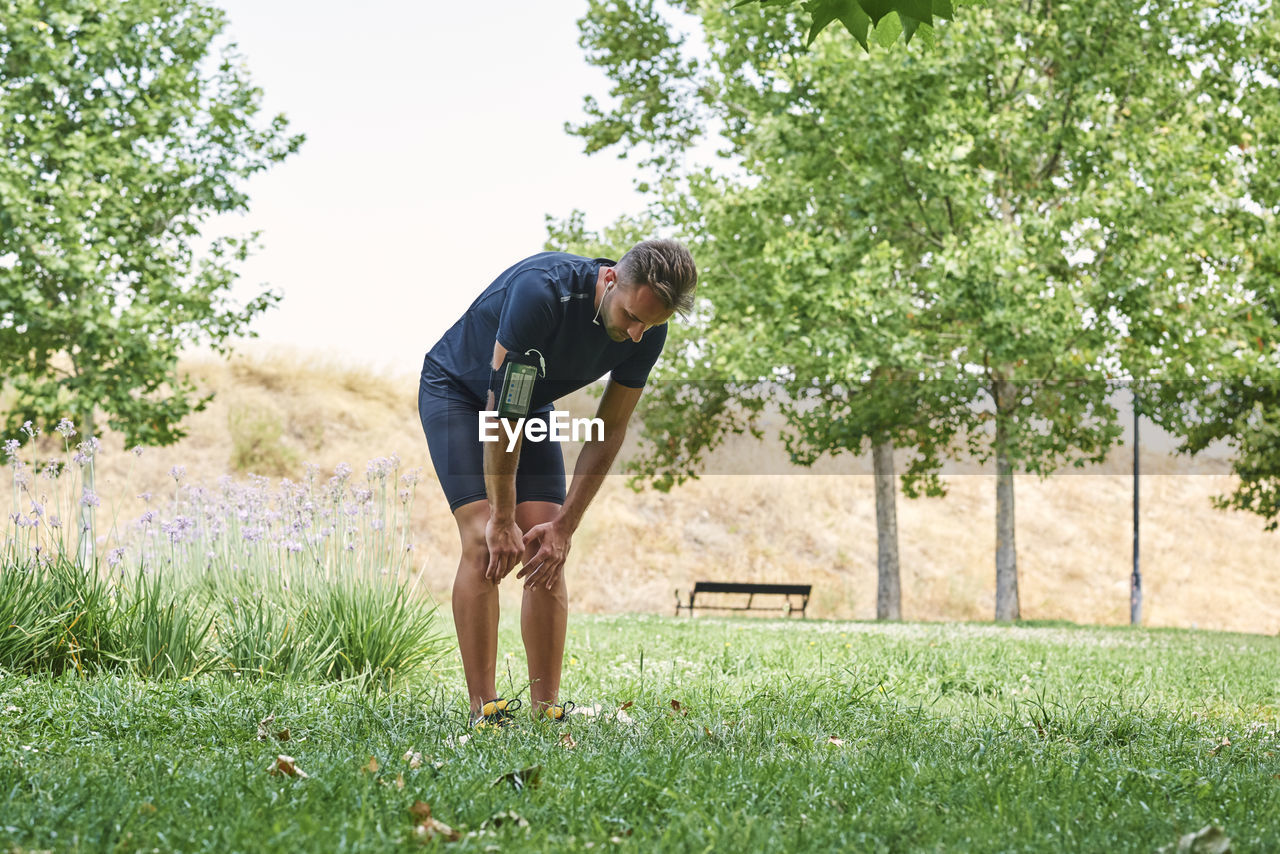 Man rests after exercise. he rests his hands on his knees. concept of healthy life and sport.