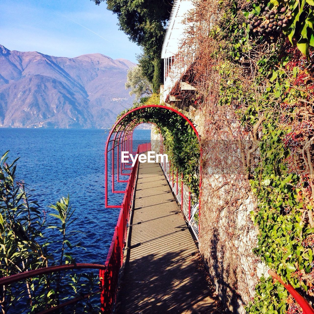 Lake como and mountain seen from walkway of varenna 