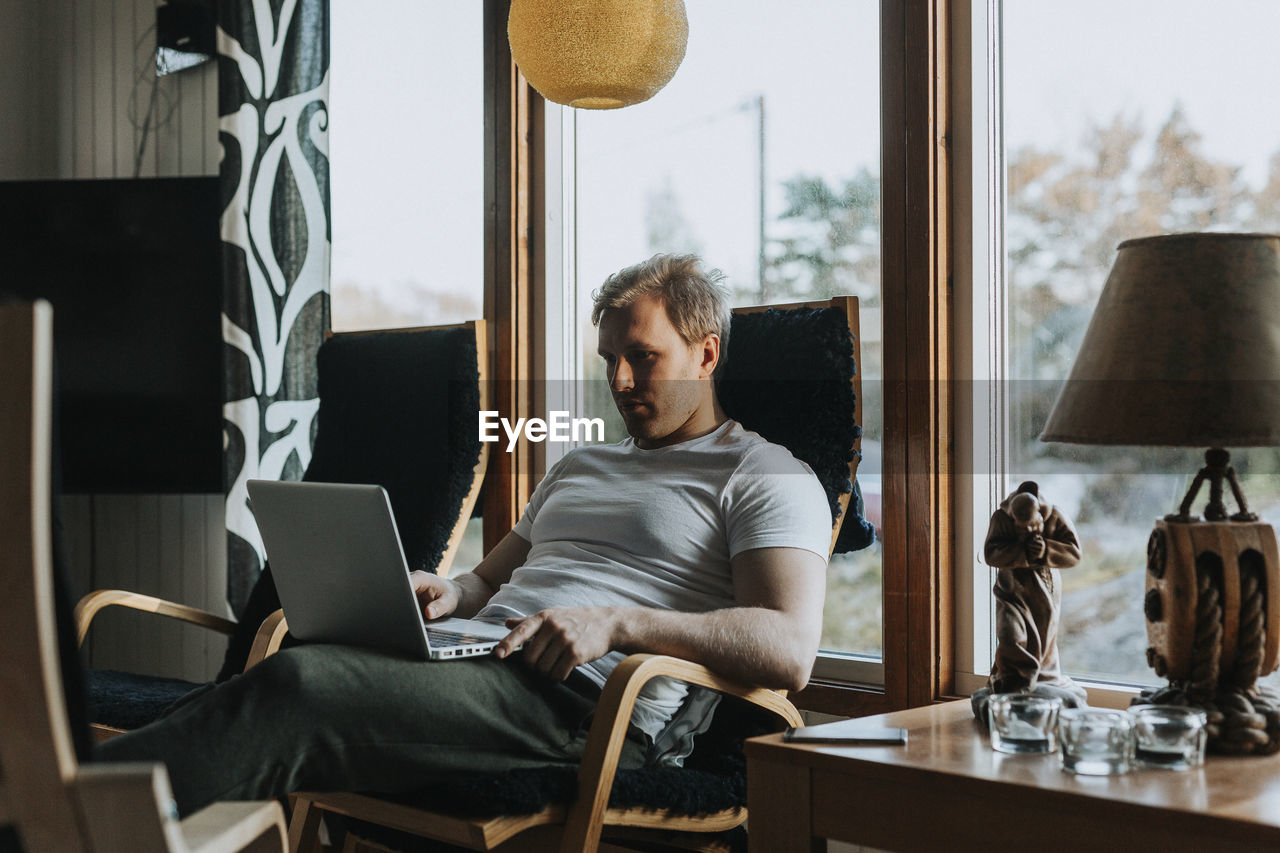 Man on chair using laptop