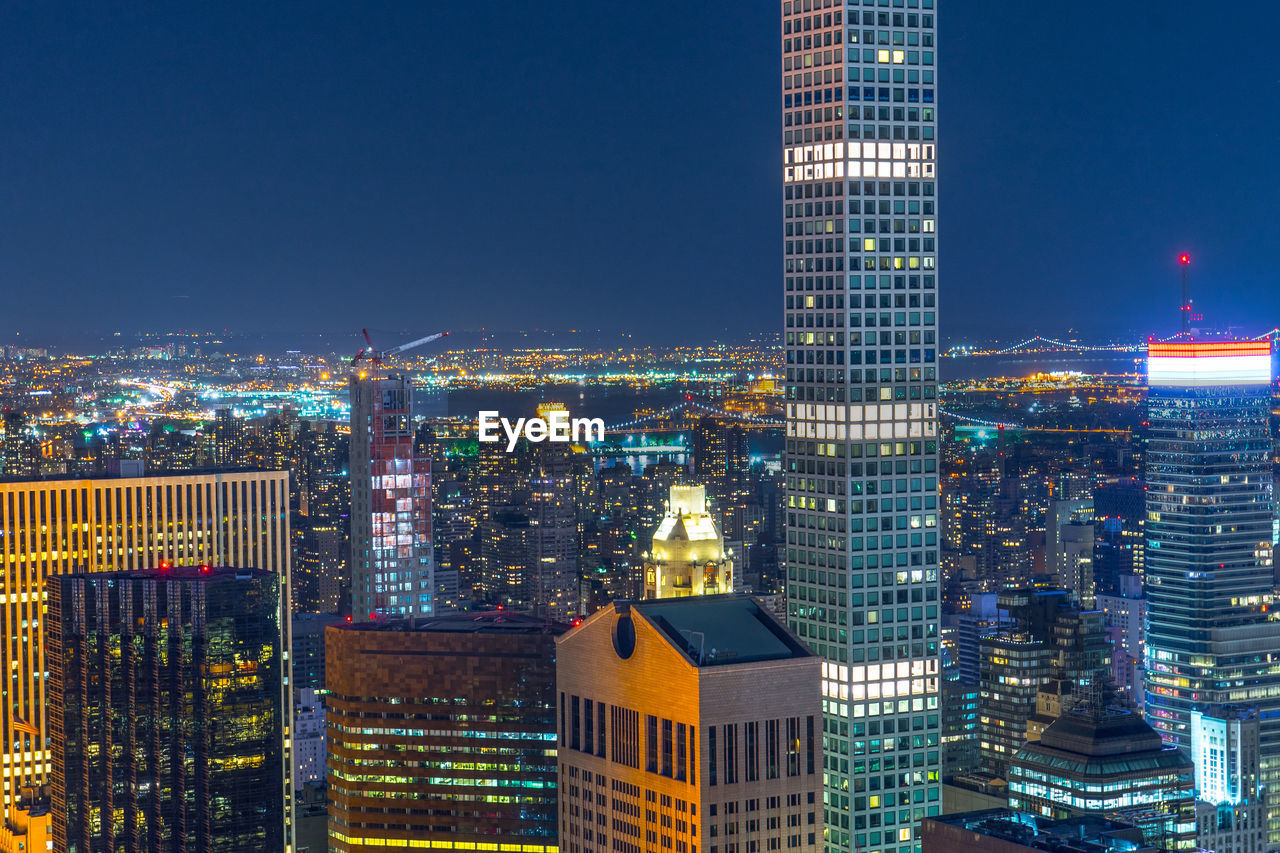 high angle view of illuminated buildings in city at night