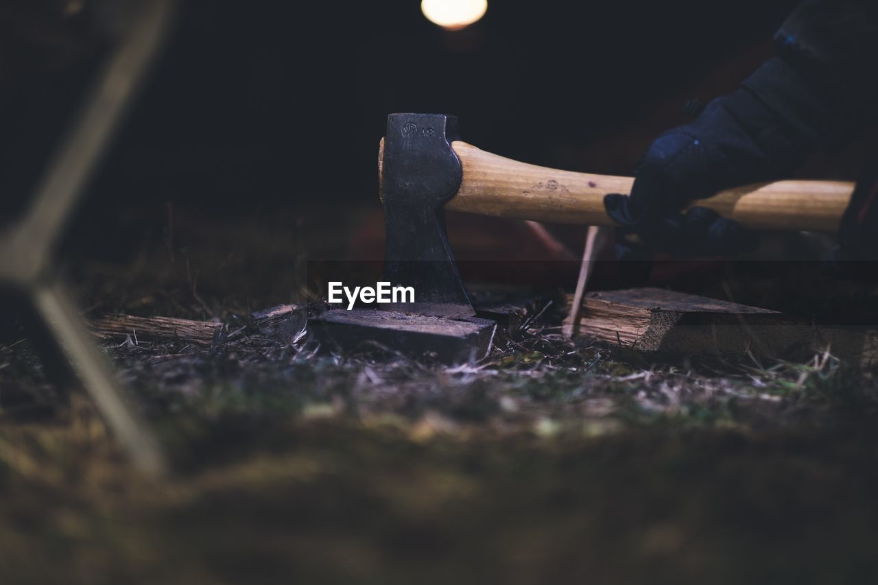 Cropped hands of man chopping wood 