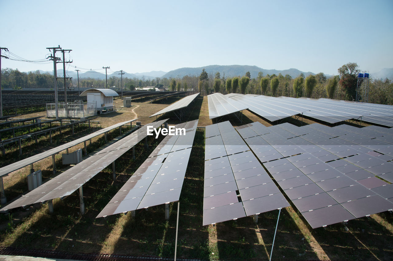 Solar farm on field against sky